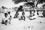 Rural school children planting trees under the instruction by their young teacher